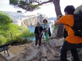 崖を背景に写真を撮る人